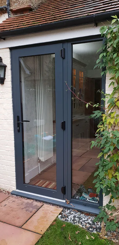 A patio with a sliding glass door leading to a patio.