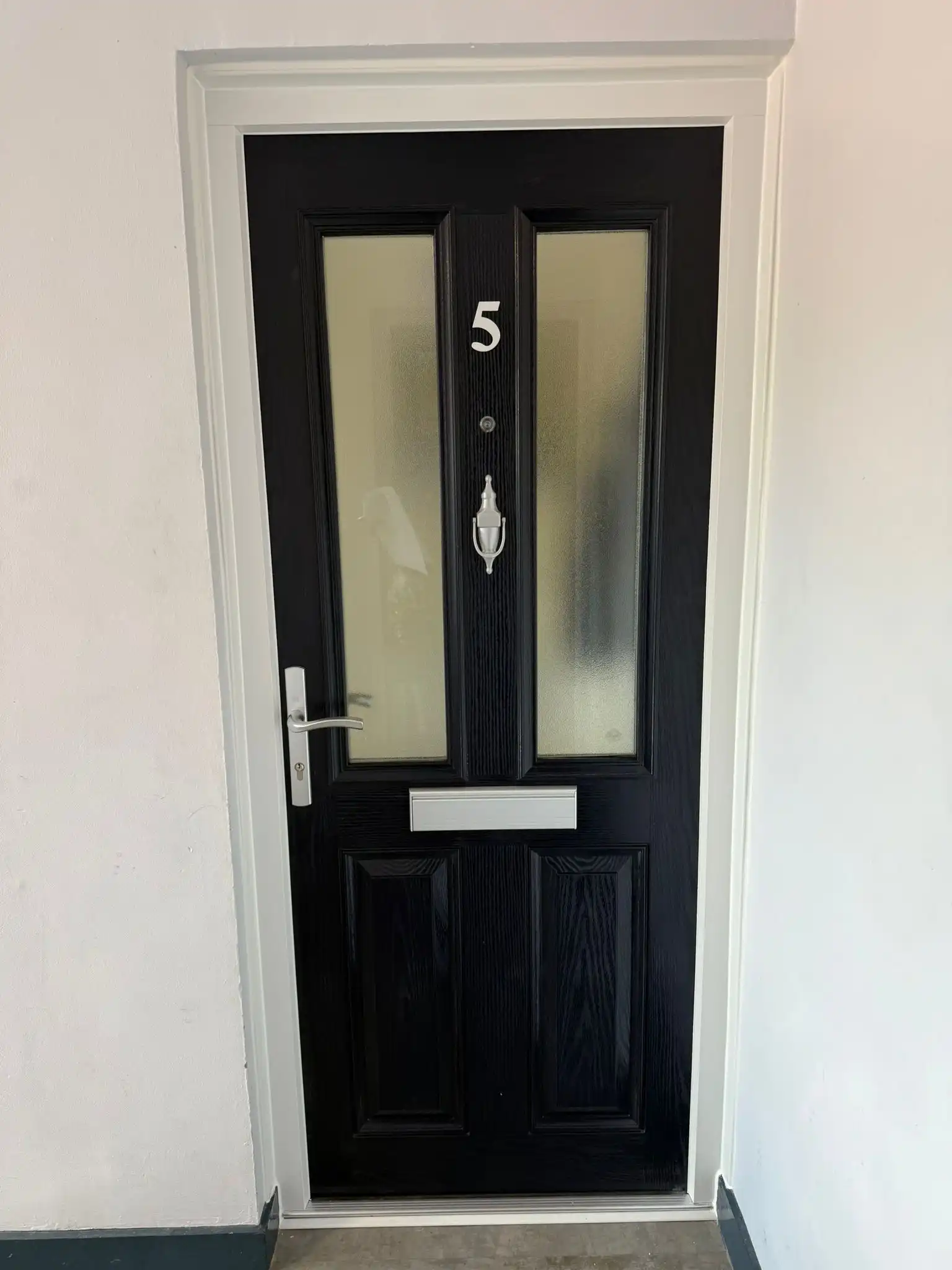 A black door with a number 5 on it.