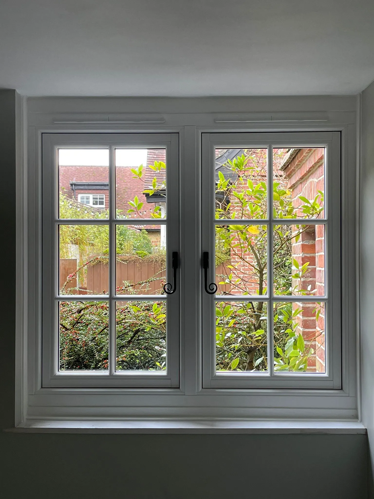 A window with a view of a garden outside.