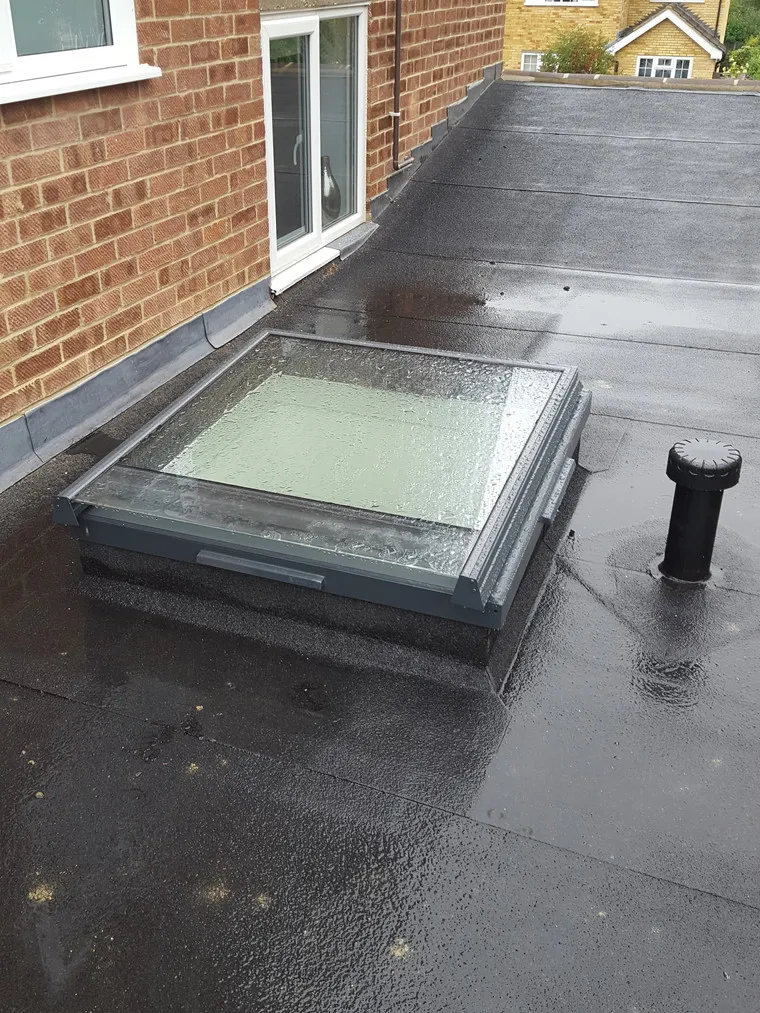 A flat roof with a rain gutter on it.